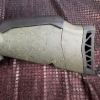 Image 14 : Ruger American bolt-action rifle chambered in 7mm-08 Rem. Features a green speckled synthetic stock,
