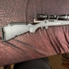 Image 1 : Ruger American bolt action rifle chambered in .243 Win, matte grey speckled synthetic stock, fluted 
