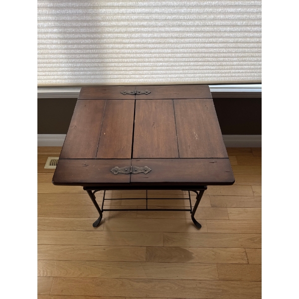 vintage side table featuring a traditional American dough box on a wrought iron stand.