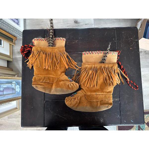 mukluks feature traditional fringe detailing, intricate beadwork on the vamp, and are lined for warm