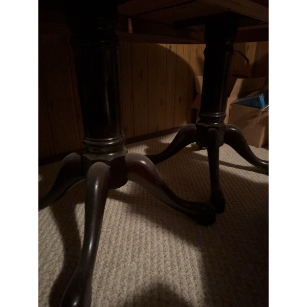 Dark wood oval dining table featuring a double pedestal base with four feet each. Includes three sep