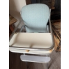 Image 2 : High chair with chrome metal frame, light blue upholstered vinyl seat and back, white footrest, and 