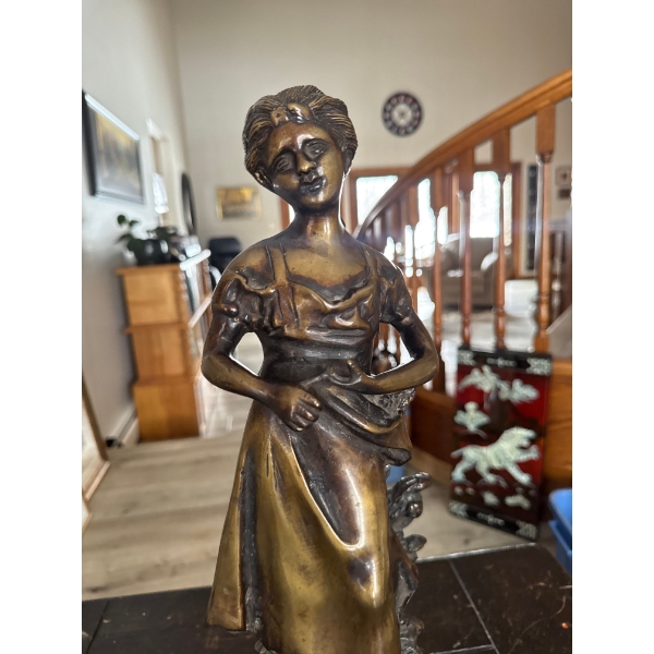  bronze figurine representing a young woman in a rustic or rural setting, characteristic of late 19t