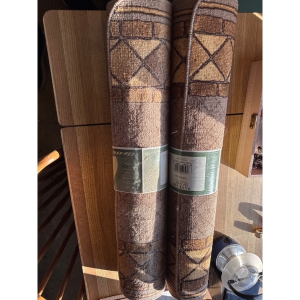 Brand new still in the wrapper. 26 inch by 60 inch pave 100% nylon entryway mats. Two of them.