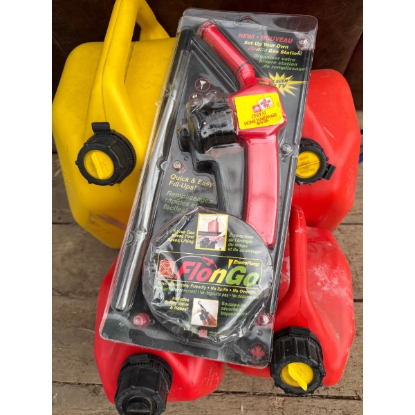 4 jerry cans, including Flow and Go Enviro pump, hand pump. It's no spill. Very nice.